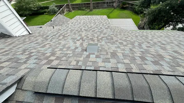 Hip ridge and dormer on a new shingle roof in northwest Houston